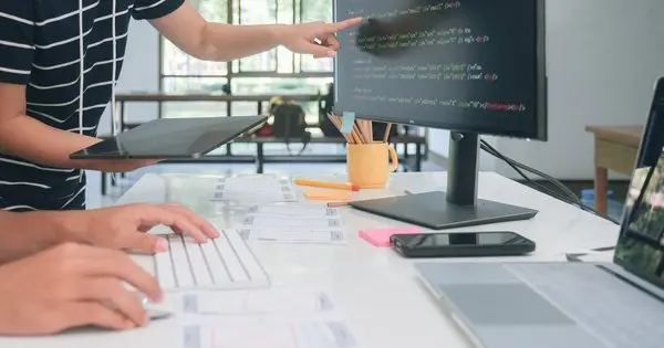 A person pointing at a computer screen